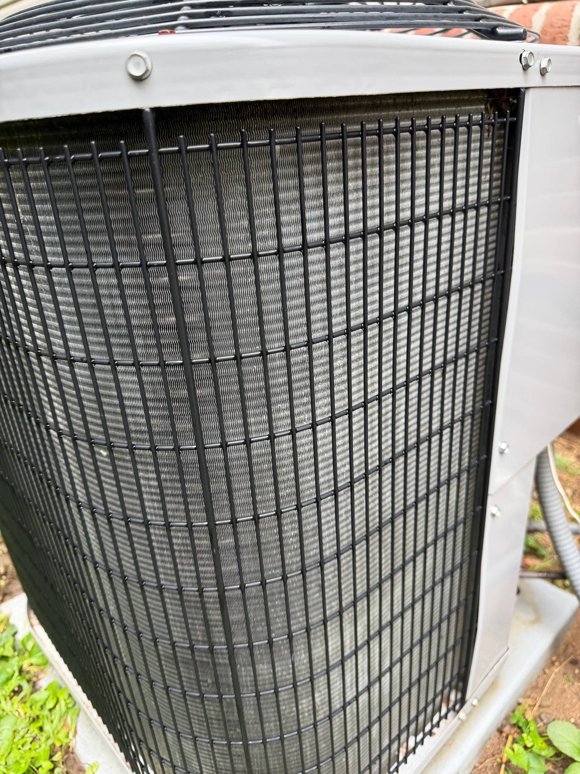 The outdoor AC condenser coil visibly cleaner after maintenance